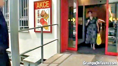 Mature BBW woman in flowy dress exits store, man waits outside