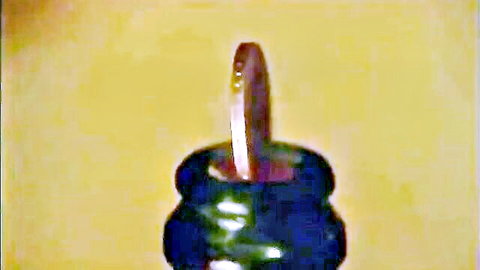 Vintage 1976 coin balanced on bottle neck in Palais-Royale teaser