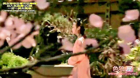 Asian beauty in pink hanfu dress posing in cherry blossom garden