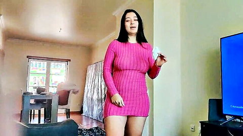 Sexy Asian MILF in tight pink ribbed mini dress talking and posing in living room