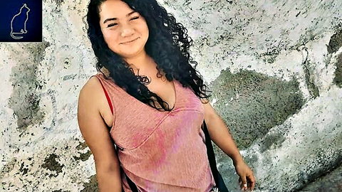Smiling curly-haired Latina in pink tank top outdoors, amateur neighbor photoshoot