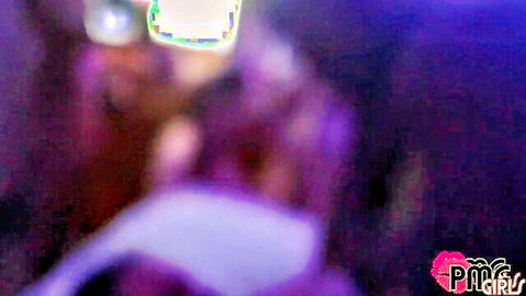 Blurry purple neon-lit adult party orgy scene with indistinct figures dancing