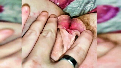 Fingers spreading open wet shaved pussy lips exposing pink vagina closeup