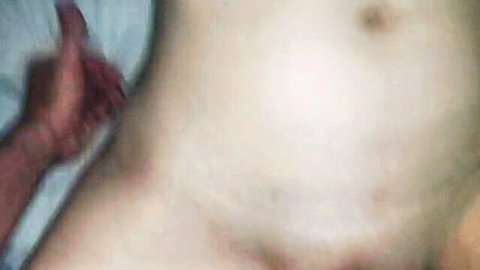 Close-up of pale woman on bed after creampie, hand on belly
