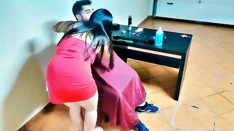 Young stud hugs sexy Asian MILF in red mini dress from behind during haircut tease
