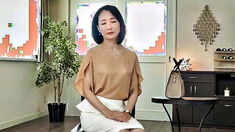Reiko Seo, mature Japanese wife in elegant beige blouse and white skirt, poised solo