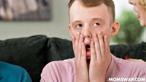 Shocked ginger teen covers mouth in surprise next to hot blonde MILF in taboo momswap scene