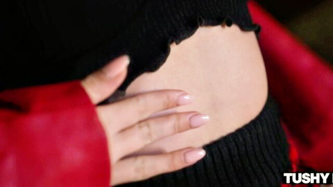 Una Fairy in black frilly crop top and red jacket, teasing her slim pale curves