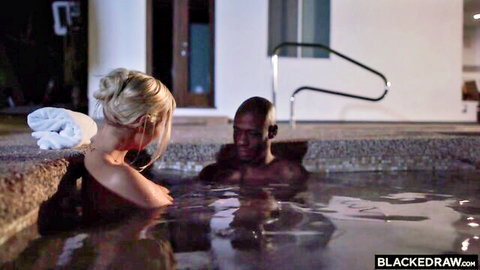 Topless blonde woman flirts with bald black stud in outdoor hot tub jacuzzi