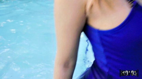 Brunette teen with small tits in tight blue swimsuit posing by pool showing sideboob