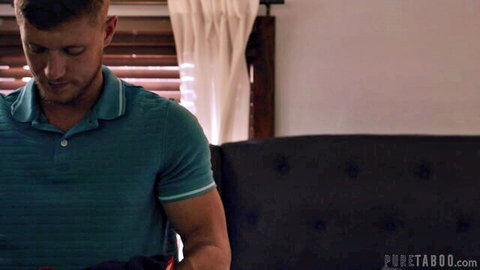 Muscular Oliver Flynn in tight teal polo shirt, intense gaze
