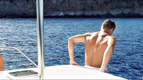 Coco de Mal shirtless muscular back on party boat overlooking sea