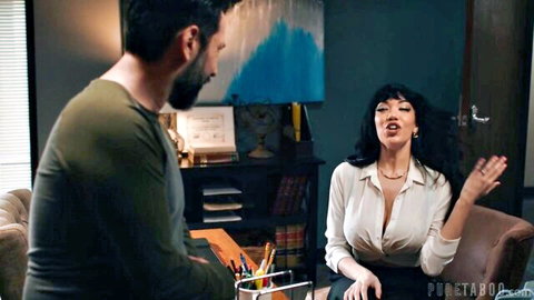 Little Puck in deep cleavage blouse chats with Tommy Pistol in sexy office scene