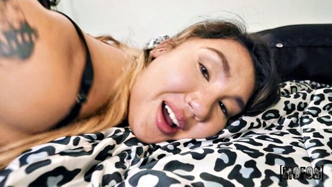 Tomie Tang in black lingerie, aroused expression on leopard bed