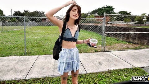 Shrooms Q in lace bralette and denim skirt, tattooed legs, outdoor Bang Bus tease