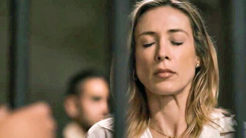 Kenzie Taylor behind bars in dramatic pose, eyes closed, from A Killer On The Loose Pt. 2