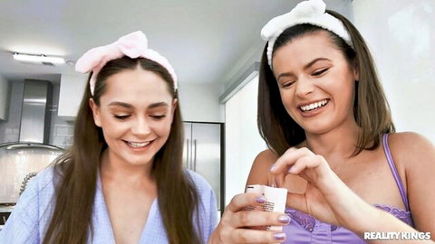 Melony Melons and Dharma Jones in lingerie and robes, smiling playfully together
