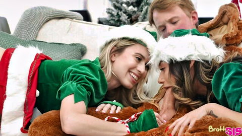 Naughty elf stepsisters in green outfits teasing intimately with guy nearby
