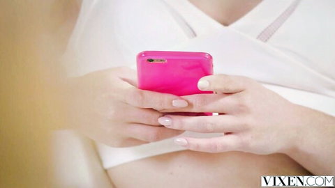 Alexa Grace in white lace lingerie holding pink phone teasingly
