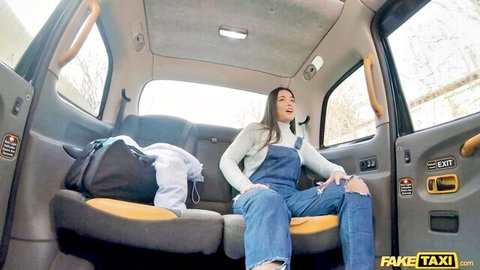Nuria Millan in Fake Taxi, smiling in denim overalls with legs spread