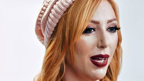 Lauren Phillips sexy redhead MILF in pink beanie, seductive gaze