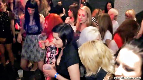 Crowd of sexy party girls in tight dresses dancing at wild club party