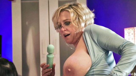 Blonde MILF with glasses exposes huge bare tits gripping green vibrator moaning ecstatically