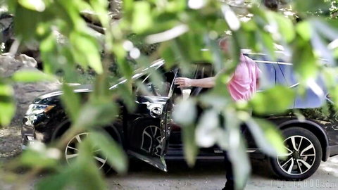Emma Jade in pink top by black SUV outdoor with Charles Dera