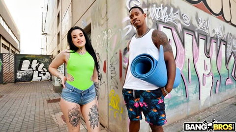 Saba Lapiedra in sexy green top and shorts with tattooed stud by graffiti wall