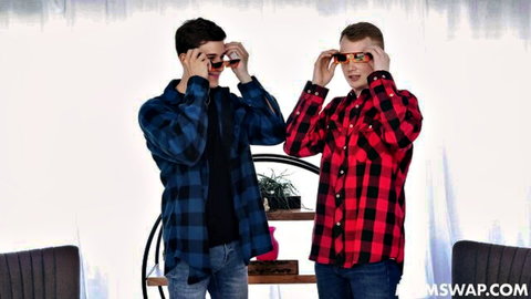 Two plaid-shirted guys posing playfully with sunglasses on wife swap site