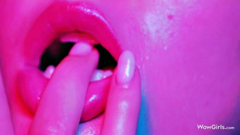 Sonya Blaze teases with fingers in her open pink lips, neon glow
