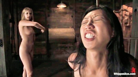 Maitresse Madeline dominates Tia Ling with whipping in nude BDSM scene
