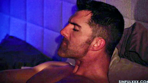 Handsome muscular man lying shirtless in bed, close-up from SinfulXXX Kiss Don't Tell 3