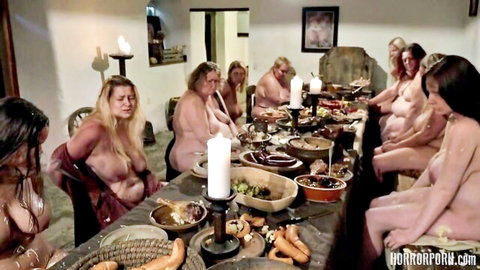 Nude curvy women feasting at table in horror porn gluttony scene