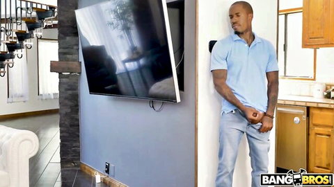 Black stud in blue polo leans casually in BangBros MILF seduction scene