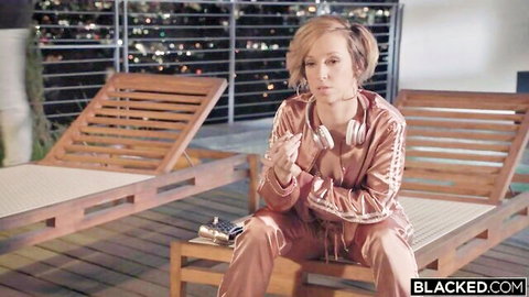 Jada Stevens in shiny pink tracksuit on balcony, craving BBC action