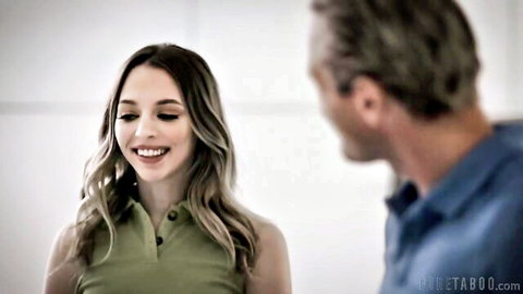 Young blonde with long wavy hair smiles flirtatiously at older gray-haired man in taboo polo shirts
