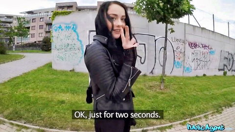Brunette babe in leather jacket shushes teasingly outdoors near graffiti wall in Public Agent public sex video