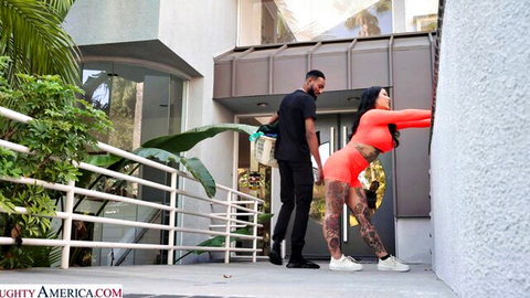 Connie Perignon in orange bodysuit bent over outdoors with BBC neighbor