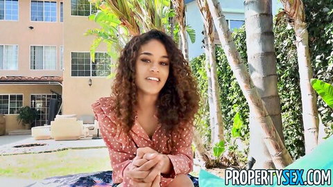 Petite ebony realtor smiling in red dress outdoors naughty tease