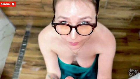Topless MILF with glasses and big tits in green towel, seductive gaze
