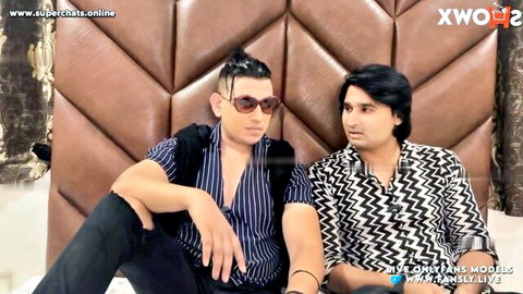 Two stylish Indian men with topknot and long hair in casual shirts posing intimately