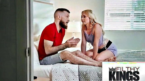 Blonde MILF in tank top talks with bearded stud on bed, teasing anal play