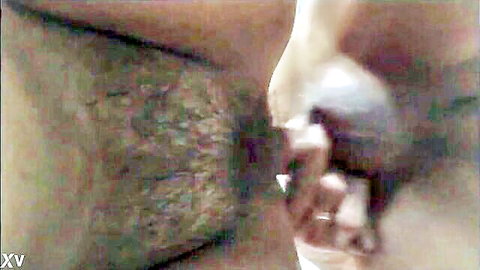 Close-up of ebony woman's big hairy pussy and ass with hand