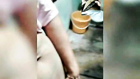 Blurry amateur thumbnail of mature old lady in pink top by bucket