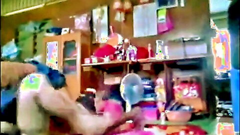 Muscular dark-skinned man teasing woman in pink top from behind