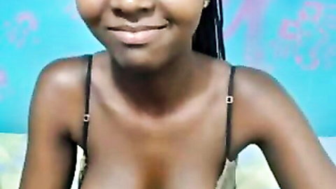 Smiling ebony babe with huge tits spilling from black bra cleavage