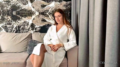 Sexy Russian woman in white spa robe, teasing legs apart post-sauna