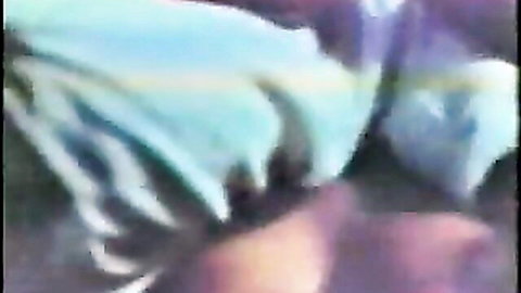 Blurry close-up of spread wet pussy lips glistening in blue neon lighting