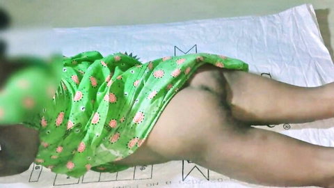 South Asian woman in green floral dress pulled up exposing bare brown ass and tight asshole spread on bed